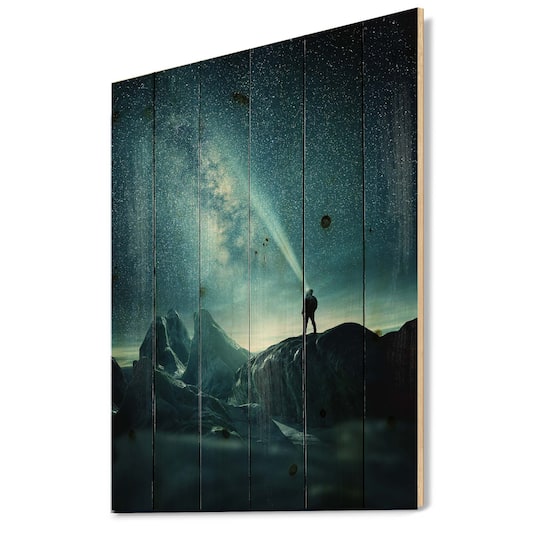Designart - A Man Shining A Light Into The Night Sky